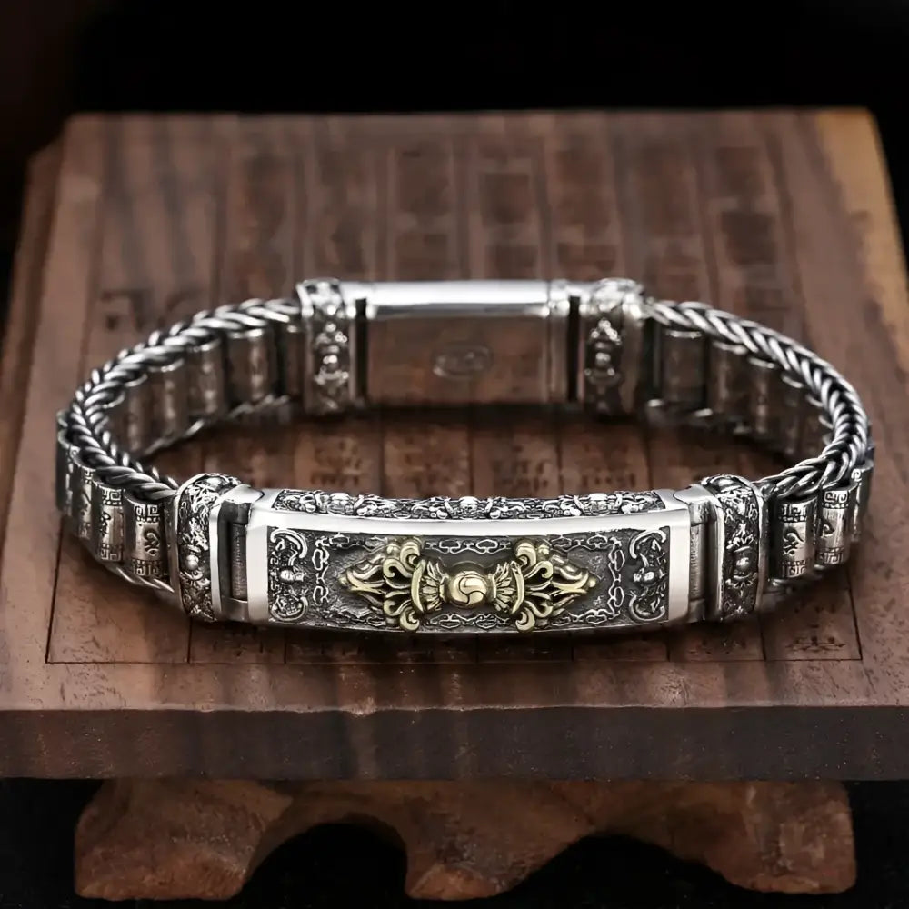 Ornate silver bracelet with golden accent.