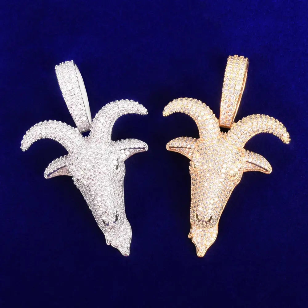 Two goat head pendants covered in gems.