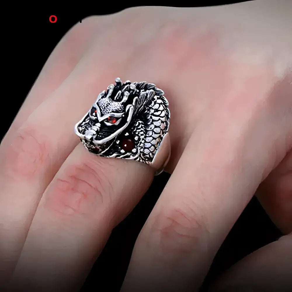 Silver dragon ring with red eyes.