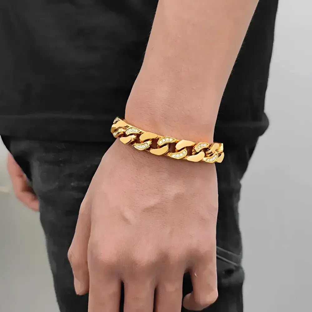 Gold chain-link bracelet with embedded gems.