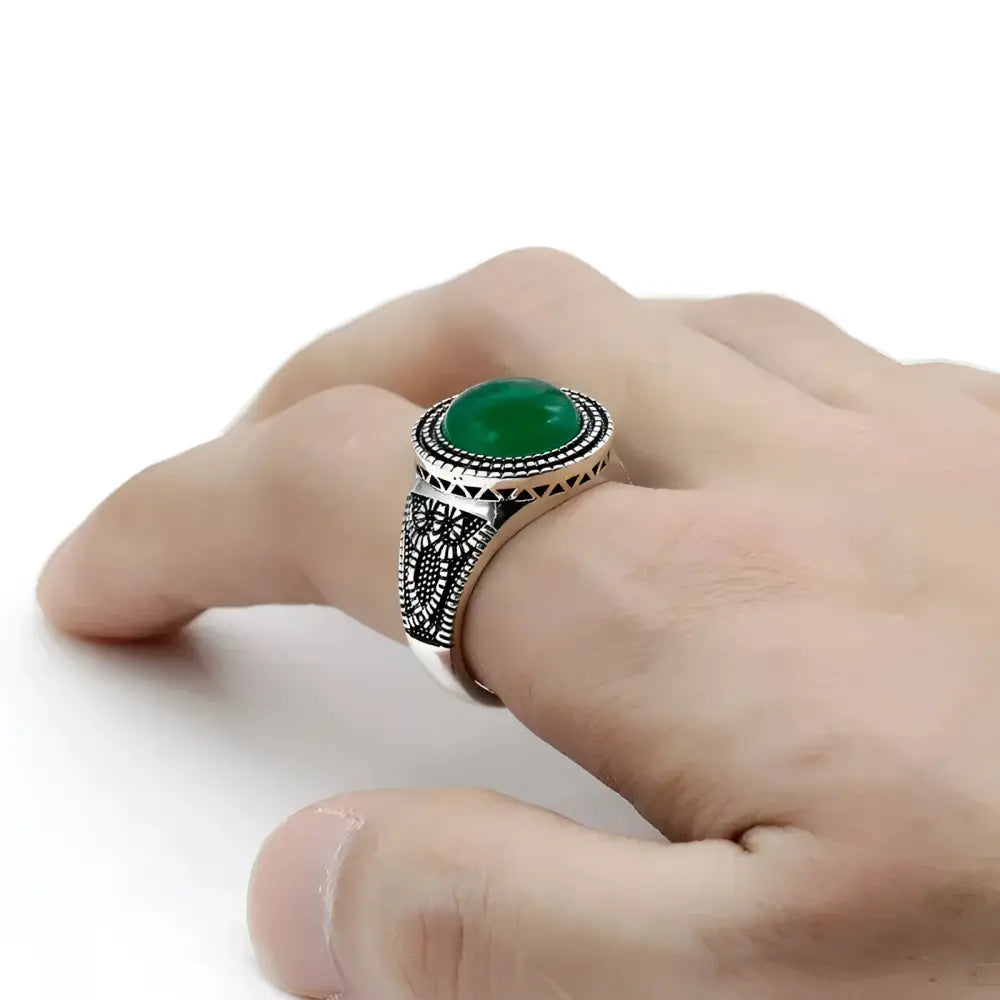 Silver ring with green stone.