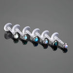 Labret lip rings with colorful opal studs.