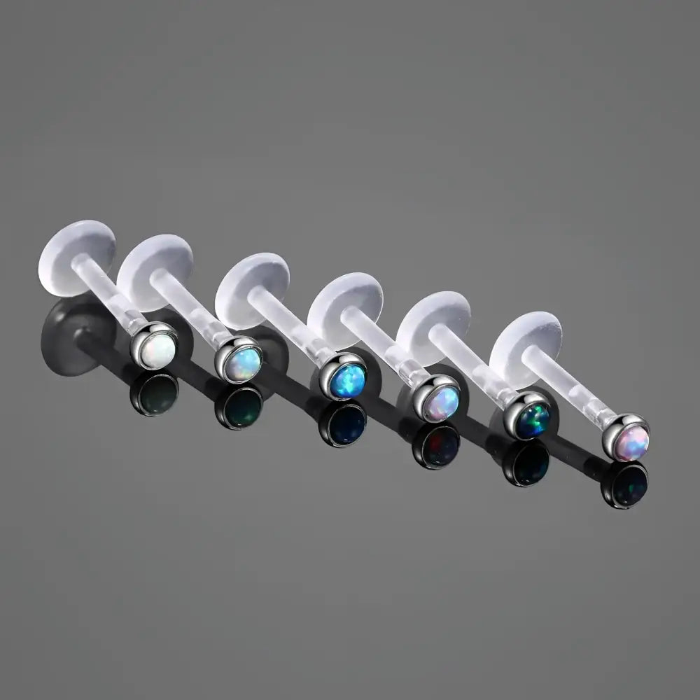 Labret lip rings with colorful opal studs.