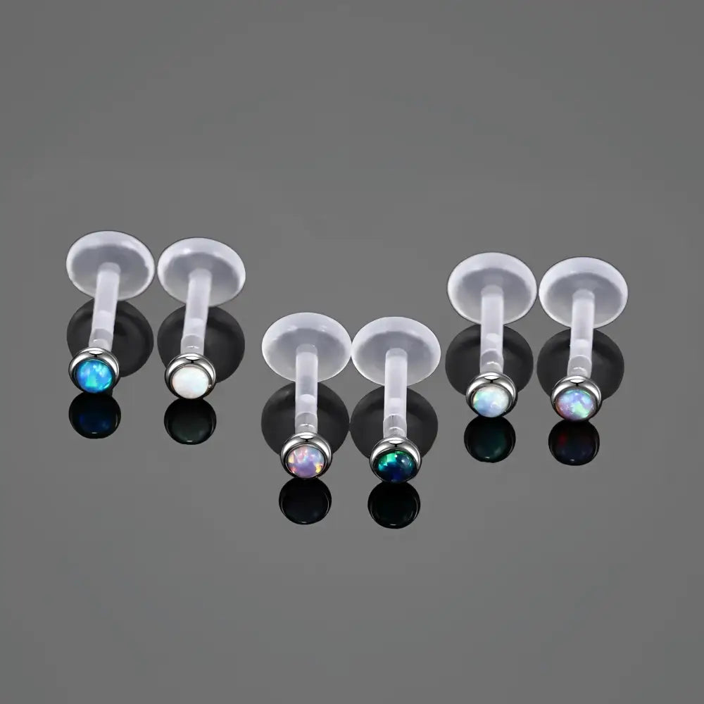 Labret piercings with opal ends.