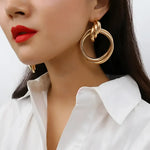 Gold triple hoop earrings.