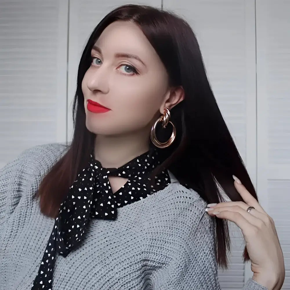 Woman with red lipstick and hoop earrings.