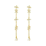 Gold-toned floral drop earrings.