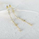 Gold-toned floral drop earrings.