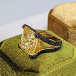 Yellow diamond ring with black accents.
