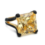 Yellow gemstone ring with black accents.