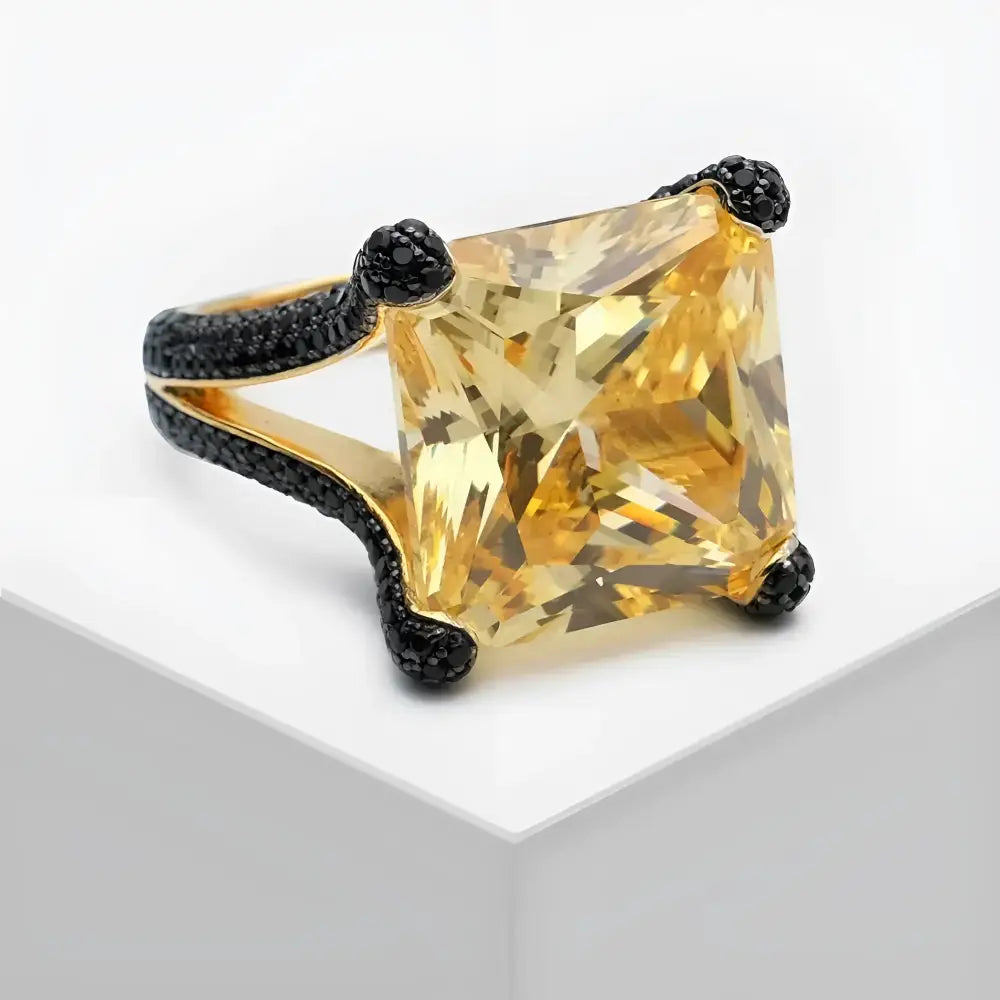 Yellow gemstone ring with black accents.