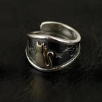 Silver ring with cat and star design.