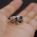 Silver ring with a golden cat.