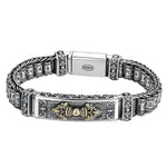 Silver bracelet with ornate details.
