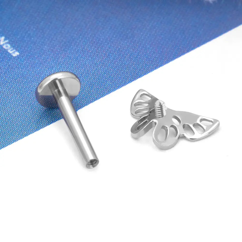 Silver labret stud and butterfly attachment.
