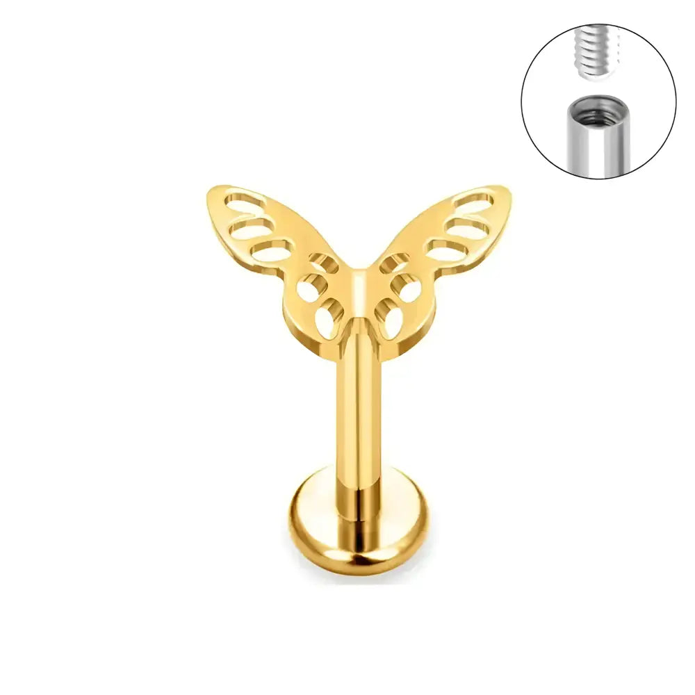 Gold butterfly labret piercing.