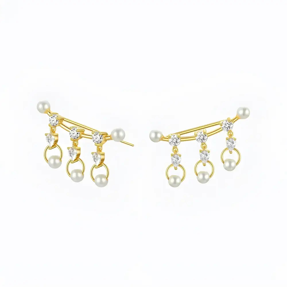 Gold-tone pearl and crystal ear climbers.