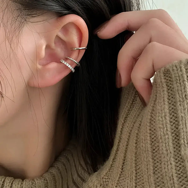 Ear adorned with ear cuff jewelry.