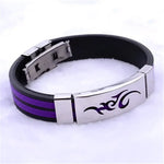 Black and purple bracelet with metal clasp and tribal design.