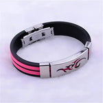 Black and pink rubber bracelet with a silver tribal design.