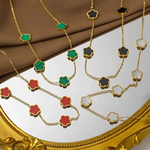 Gold necklaces with clover-shaped pendants.