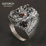 Silver dragon ring with red gemstones.