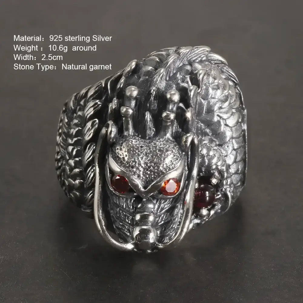 Silver dragon ring with garnet eyes.