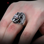 Silver dragon ring with red eyes.