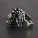 Silver dragon ring with red eyes.