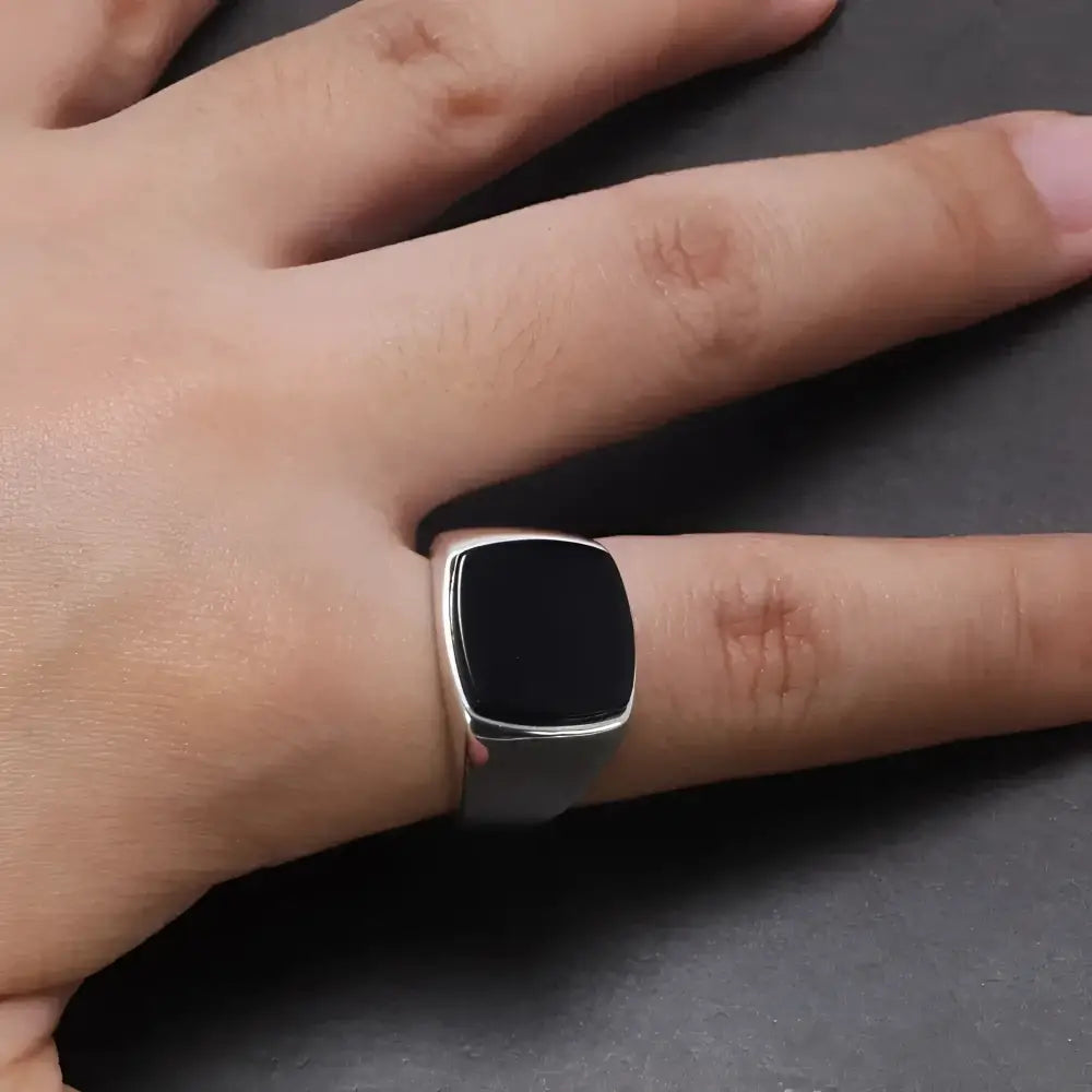Silver ring with black stone.