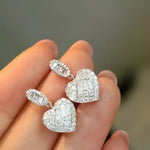 Sparkling heart-shaped diamond earrings.