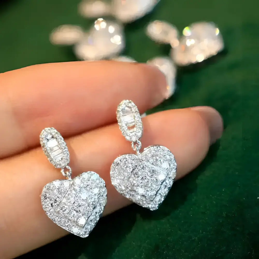 Sparkling heart-shaped diamond earrings.