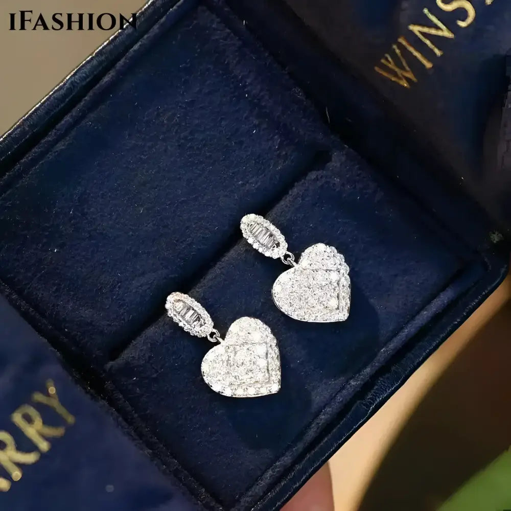 Sparkling heart-shaped diamond earrings.