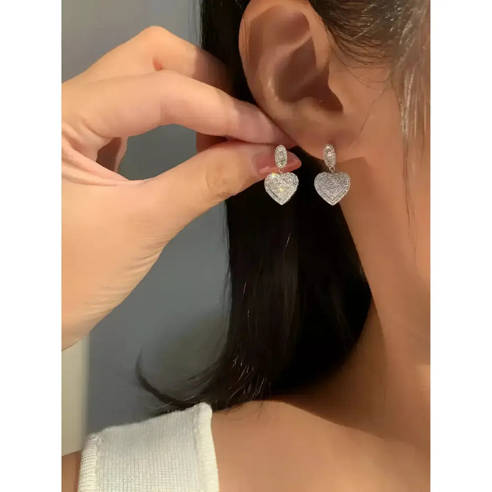 Sparkly heart-shaped earrings.