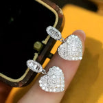 Sparkly heart-shaped earrings.