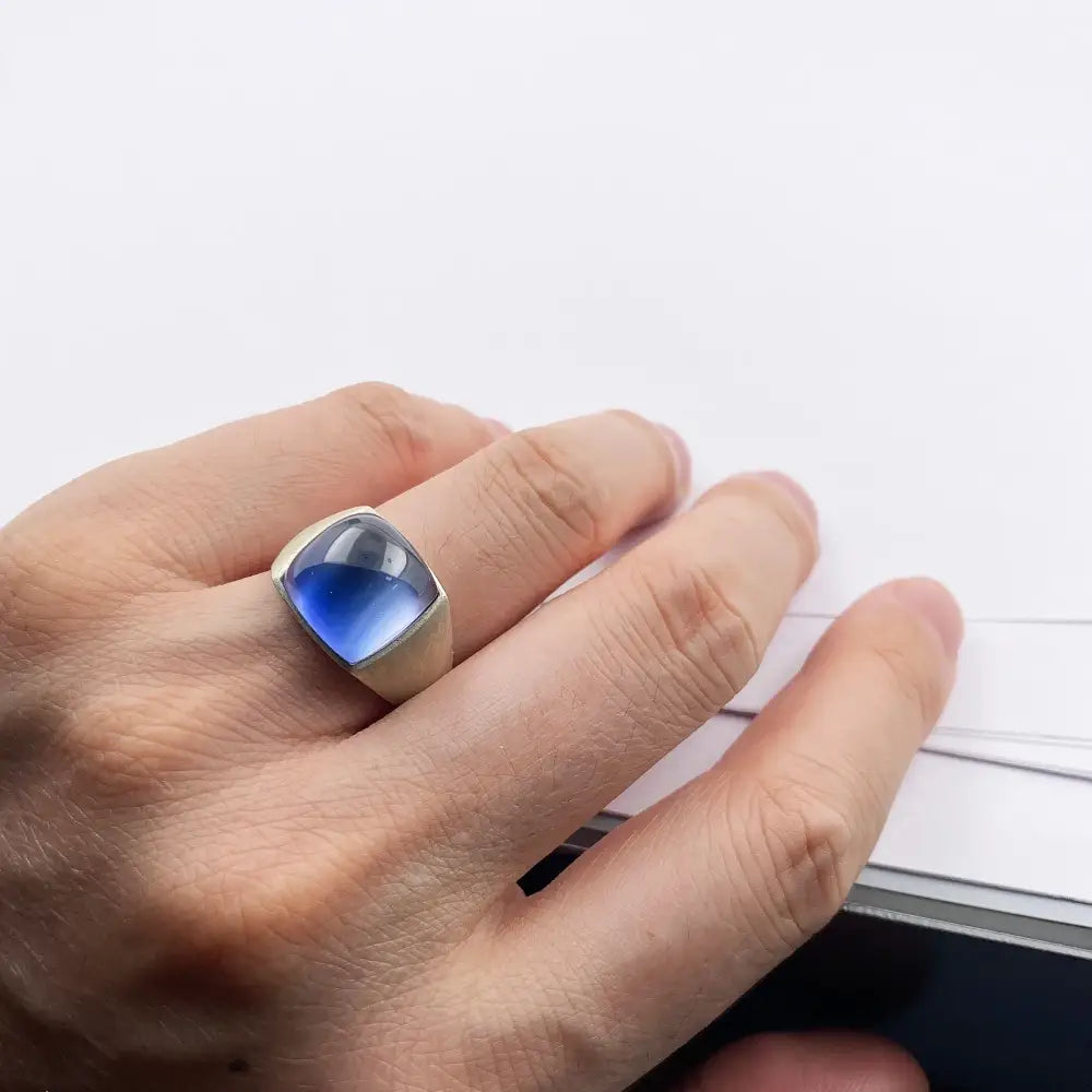 Silver ring with blue stone.