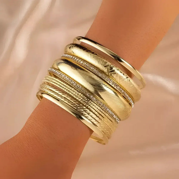 Gold bangle bracelet stack.