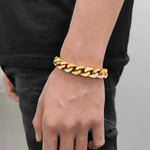 Gold chain-link bracelet with embedded gems.