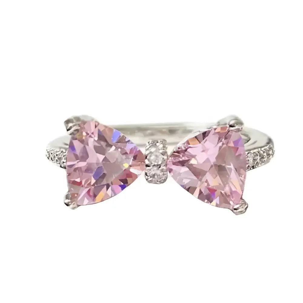 Silver ring with pink bow.