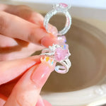 Silver rings with pink heart-shaped stones.