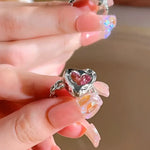 Silver heart ring with pink stone.