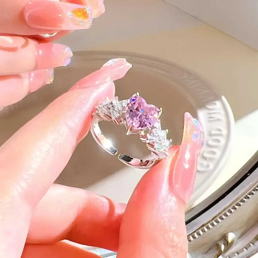 Silver ring with pink heart-shaped stone.