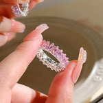 Silver ring with pink gemstones.