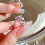 Silver ring with pink heart, pearl, and star.