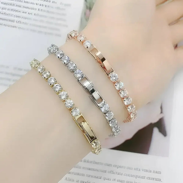 Three crystal-studded bracelets.