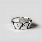 Silver ring with etched leaf pattern.