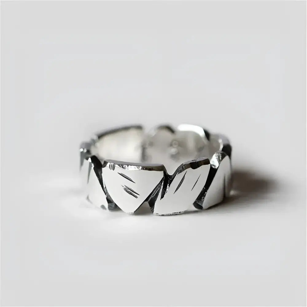 Silver ring with etched leaf pattern.