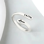 Silver-colored ’Faith’ ring with cross.