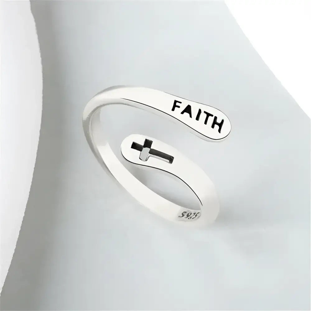 Silver-colored ’Faith’ ring with cross.