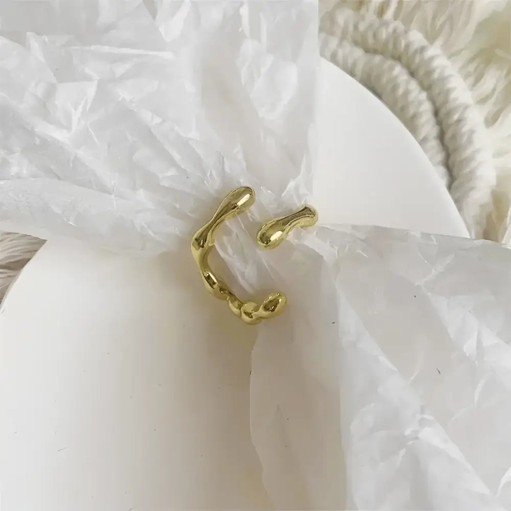 Abstract gold-colored ring.